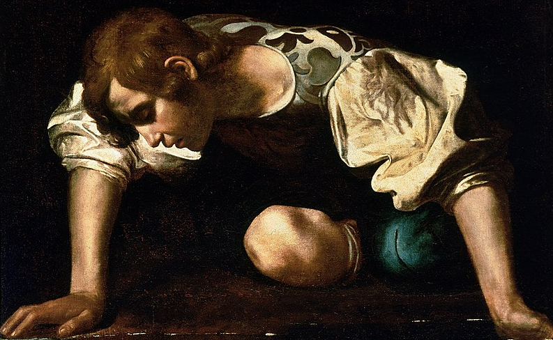 A boy with brown curls crouching above a pool of water, entranced by his own reflection.